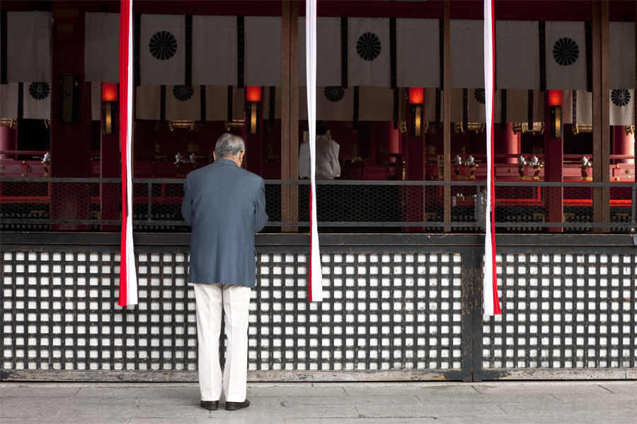 Praying at Fushimi-Inari Taisha, Kyoto, Japan